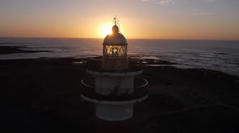 AERIAL: Flying over the lighthouse at sunset Stock Footage 37691073