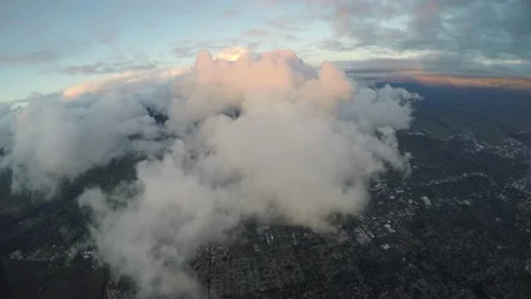 Aerial flying over puffy clouds after sunset Stock Footage 237884279