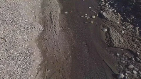 AERIAL: Flying over river bed with trees, stones and sand, Vallemaggia Stock Footage 55855309