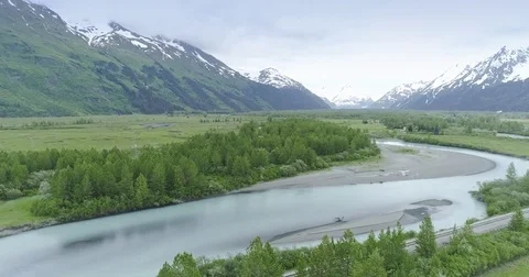 Aerial: flying over river, mountain &amp; trees near, Chugach Forest, Anchorage, Stock Footage 77708244