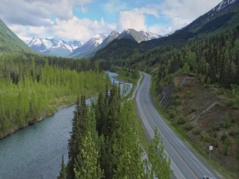 Aerial: flying over river, mountain & trees near, Chugach Forest, Anchorage, Stock Footage