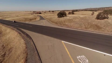 Aerial. Flying over the road through the field   Stock Footage 50996400