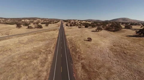 Aerial. Flying over the road through the farm field   Stock Footage 50996779