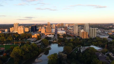Aerial flying over Thames River London Ontario skyline during sunset Stock Footage