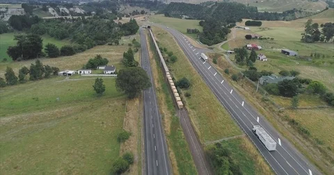 Aerial: flying over train transporting goods in New Zealand Stock Footage 76119540