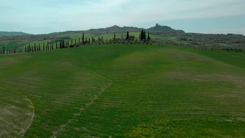 Aerial flying over Tuscany fields in parallel to single-standing villa Stock-Footage 90076997