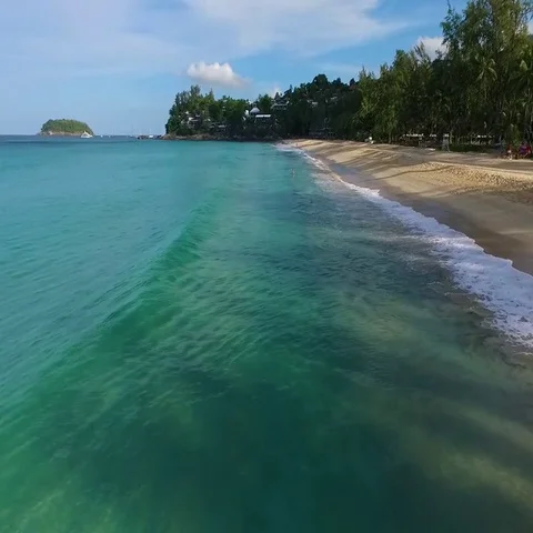 Aerial: Flying over the waves on Kata Noi beach. Stock Footage 69729862
