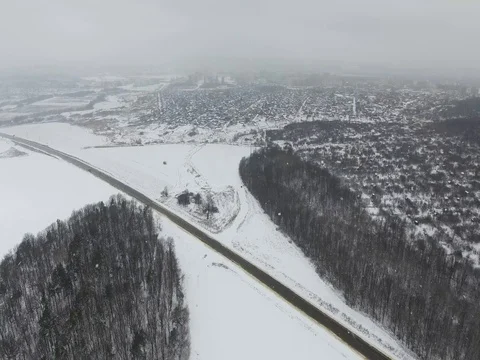 Aerial flying over winter forest and the road. Video stock 74053067