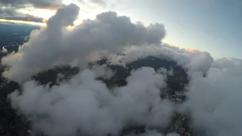 Aerial flying past clouds at sun down Stock Footage 237884262