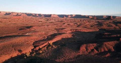 Aerial flying in reverse high over red desert alien landscape Stock Footage 119929275