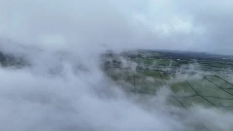 Aerial Flying Through Low Clouds Over Green Countryside in 4K 60fps Stock Footage 332567202