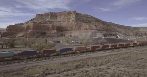Aerial Flying toward Cargo Train in American Desert Stock Footage 75982040
