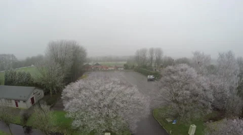 Aerial flying towards closed sport facility winter frozen trees tennis court 4k Stock Footage 59320003