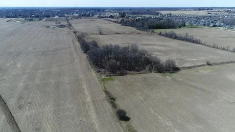 Aerial Flying Towards Forest Patch Of Agricultural Land Early Spring Vídeos de archivo 254273823