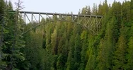 Aerial - Flying Under An Abandoned Train Bridge In The Pacific Northwest Stock Footage