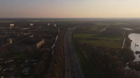 Aerial flyover above highway traffic near Vlijmen at sunset Stock Footage 335832003