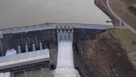 Aerial Flyover of Clyde Dam with Open Spill Gates and Reservoir, Clutha River Stock Footage 346451610