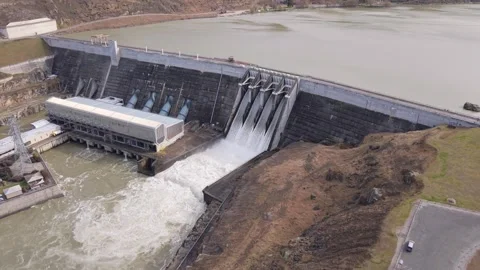 Aerial Flyover of Clyde Dam Spill Gates Open on Clutha River, New Zealand Stock Footage 346453490