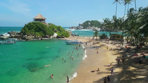 Aerial flyover of crowded Cabo San Juan beach with tourists at Parque Tayrona Vídeos de archivo 337391324