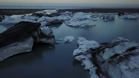 Aerial flyover of melting ice structures near land Stock Footage 166862932