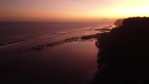 Aerial Flyover of Ocean Cliffs and Waves During Sunset Bali Stock-Footage 332696961