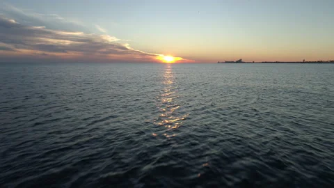 Aerial Flyover of Ocean Waves at Sunset Stock Footage 136485299