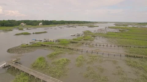Aerial flyover of properties by a marsh Video stock 167372107