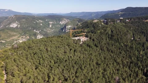 Aerial Flyover of Resort Construction Site with Cranes on Trebevic Mountain Stock-Footage 342939999