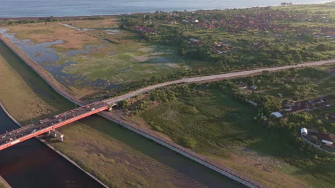 Aerial Flyover of River with Bridge and Village Stock Footage 344872482