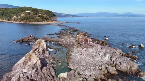 Aerial Flyover of Rocky Path Leading to Mitsuishi Rocks Manazuru 4K Stock Footage 329058555