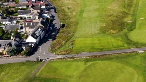 Aerial Flyover of Scottish Golf Course Adjacent to Village Vídeos de archivo 321664096