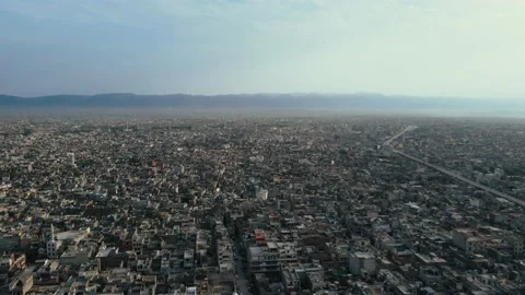 Aerial Flyover Shot of dense population around Muree road Rawalpindi City Stock Footage 236411566
