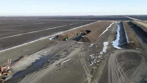 Aerial flyover showing large rows of harvested sugar beets being loaded. Stock Footage 157768439
