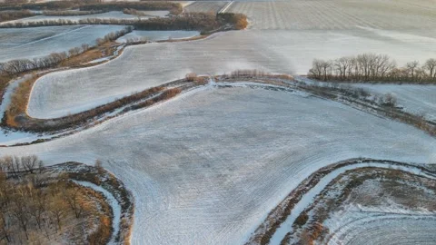 Aerial flyover of snowy fields and frozen river in rural North Dakota. Stock Footage 157768491