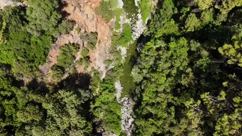 Aerial flyover tracking river upstream through gorge, Benahavis, Spain Stock Footage 339590439