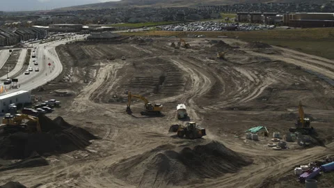 Aerial flyover view of construction machinery developing subdivision / Riverton, Video stock 167312564