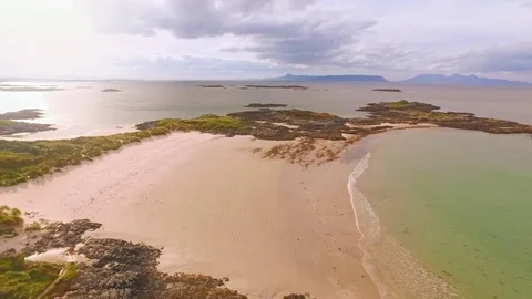 Aerial flyover of a wild, desolate beach in Scotland. Stock Footage 74137730