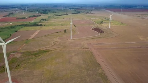 Aerial flyover of wind farm with multiple wind turbines in Oklahoma. Stock Footage 100083743