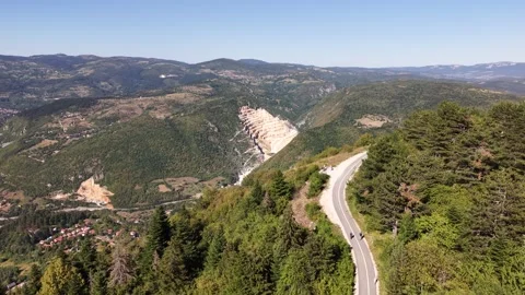Aerial Flyover of Winding Path on Trebevic Mountain Revealing Distant Quarry Stock-Footage 342939335