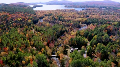 Aerial flythrough of Winding River Through Autumn Trees with Fall Colors in N Stock Footage 141783690