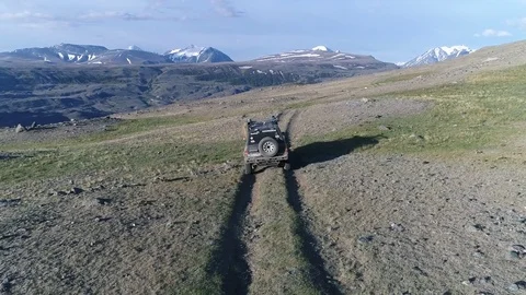 Aerial follow SUV car on the mountain road Stock Footage