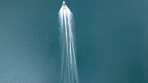Aerial follow top down view of person wakeboarding on a lake. Stock Footage 149336130