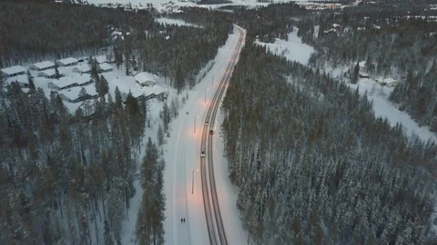 Aerial following a car in winter, Finnish Lapland. 4K. Stock Footage