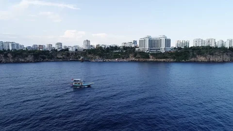 Aerial-Following the sightseeing boat with coastal background Stock Footage