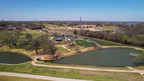 Aerial footage approaching Unity park in Highland Village Texas and flying Stock Footage 189922281