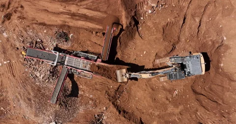 Aerial footage of Bagger loading unfiltered sand into Sand cleaning crusher Stock Footage 237501566