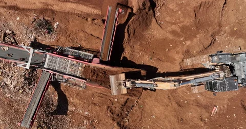 Aerial footage of Bagger loading unfiltered sand into Sand cleaning crusher Stock Footage 237501666