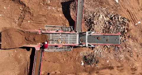 Aerial footage of Bagger loading unfiltered sand into Sand cleaning crusher Stock Footage 237507953
