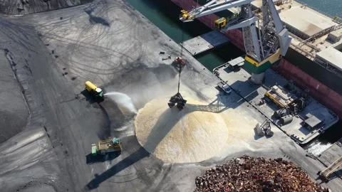 Aerial footage of a bulk cargo ship being loaded with dry material Stock Footage 345659541