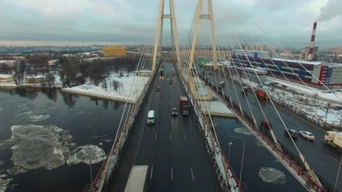Aerial footage of a cable-stayed bridge, ice moving along the river Stock Footage 172541248